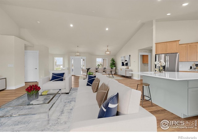 3643 Crested Owl Ct, Dacono, CO 80514 - living room with light wood-type flooring, high vaulted ceiling, and recessed lighting