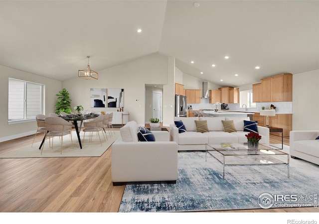 3643 Crested Owl Ct, Dacono, CO 80514 - living room with light wood-type flooring, a chandelier, recessed lighting, and high vaulted ceiling