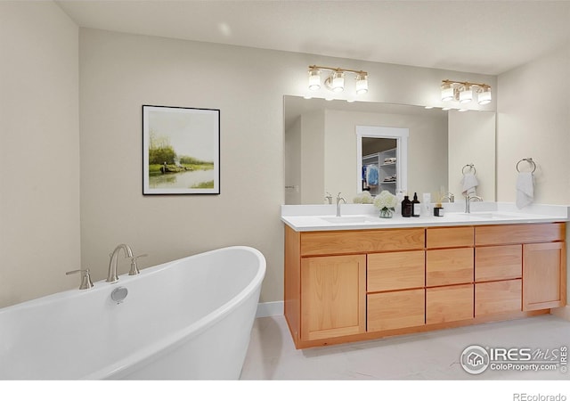 3643 Crested Owl Ct, Dacono, CO 80514 - bathroom featuring double vanity and a freestanding bath