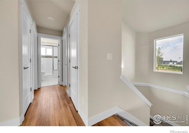 3643 Crested Owl Ct, Dacono, CO 80514 - corridor featuring light wood-type flooring and baseboards