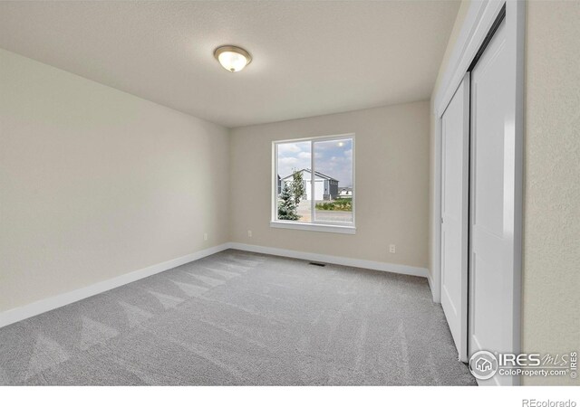 3643 Crested Owl Ct, Dacono, CO 80514 - unfurnished bedroom with carpet flooring and a closet