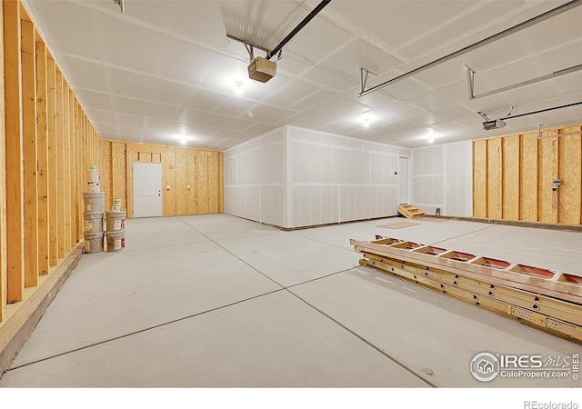 3643 Crested Owl Ct, Dacono, CO 80514 - garage featuring a garage door opener and wooden walls