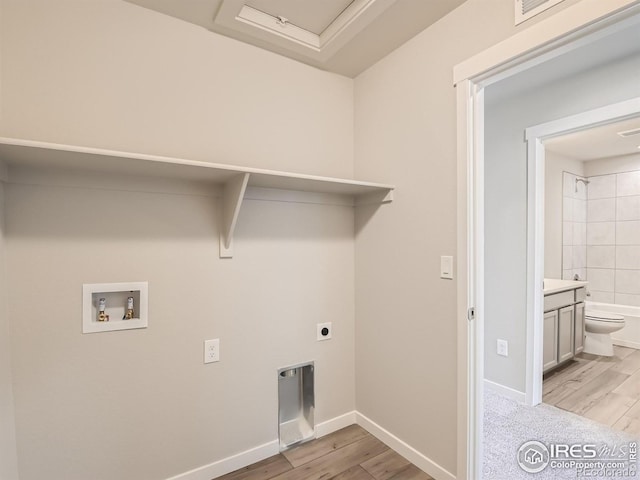 13 Chipeta Way, Lochbuie, CO 80603 - washroom with hookup for a washing machine, hookup for an electric dryer, and light wood-type flooring