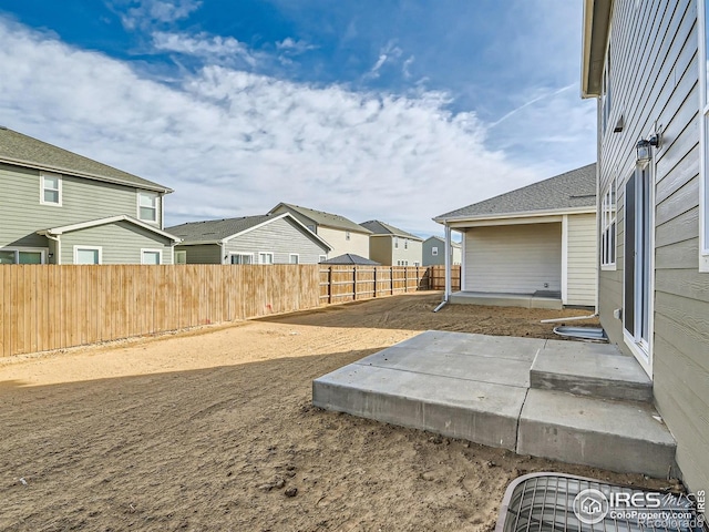 13 Chipeta Way, Lochbuie, CO 80603 - fenced backyard with a patio and a residential view