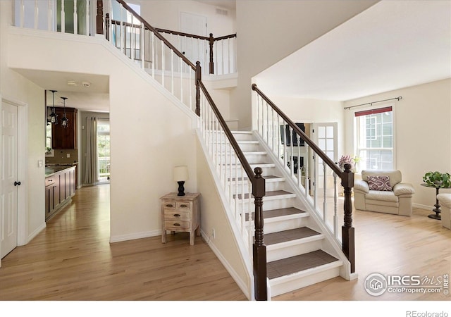 691 Tamarisk Ct, Louisville, CO 80027 - stairs featuring wood finished floors and a towering ceiling