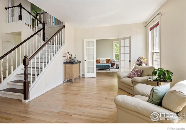 691 Tamarisk Ct, Louisville, CO 80027 - living area featuring french doors, wood finished floors, and stairs