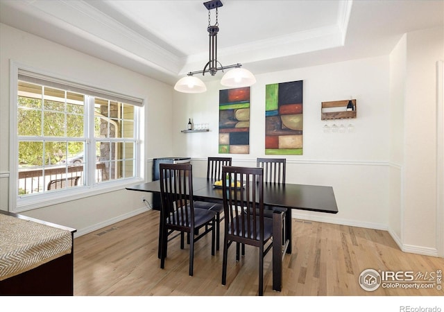 691 Tamarisk Ct, Louisville, CO 80027 - dining space with wood finished floors, crown molding, and a tray ceiling