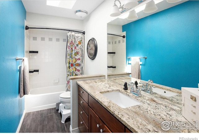 691 Tamarisk Ct, Louisville, CO 80027 - full bath featuring wood finished floors, vanity, shower / bath combination with curtain, and a skylight