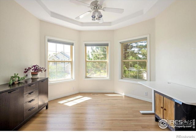 691 Tamarisk Ct, Louisville, CO 80027 - unfurnished dining area with light wood-style flooring, healthy amount of natural light, a tray ceiling, and ceiling fan