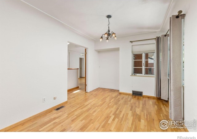 2940 9th St, Boulder, CO 80304 - unfurnished room featuring wood finished floors and a chandelier