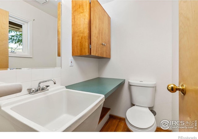 2940 9th St, Boulder, CO 80304 - bathroom with wood finished floors and decorative backsplash