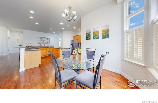 555 S 17th Ave, Brighton, CO 80601 - dining area featuring wood finished floors, recessed lighting, and a chandelier