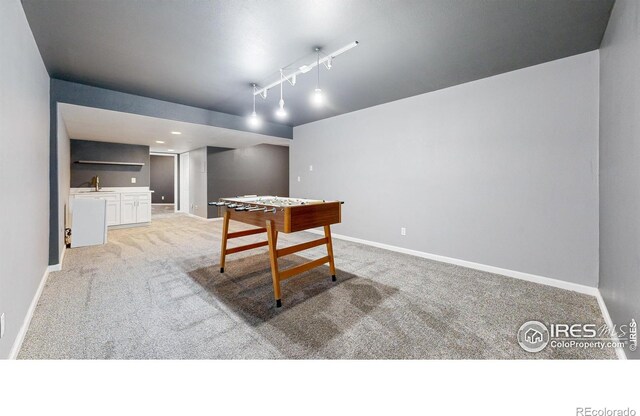 555 S 17th Ave, Brighton, CO 80601 - recreation room featuring light colored carpet, bar, and rail lighting