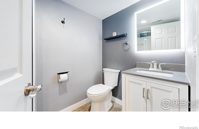 555 S 17th Ave, Brighton, CO 80601 - bathroom featuring vanity and wood finished floors