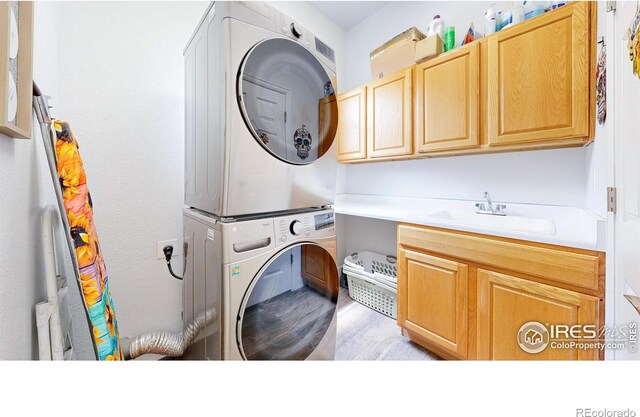555 S 17th Ave, Brighton, CO 80601 - washroom with cabinet space, stacked washer and clothes dryer, and light wood-type flooring