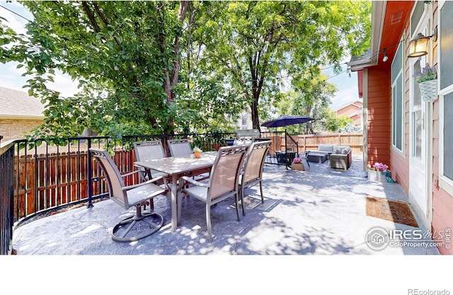 555 S 17th Ave, Brighton, CO 80601 - fenced backyard with an outdoor hangout area, outdoor dining area, and a patio