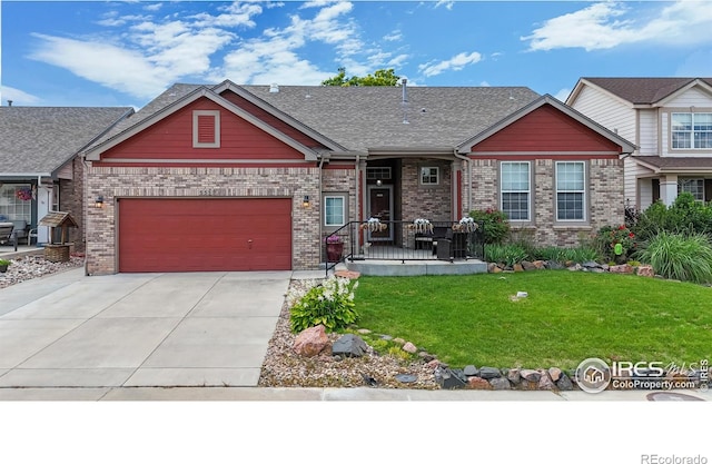 555 S 17th Ave, Brighton, CO 80601 - craftsman house featuring a front yard, driveway, a garage, and brick siding