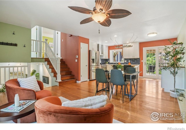 1430 Kennedy Ave, Louisville, CO 80027 - living area featuring light wood-type flooring, ceiling fan, and stairway