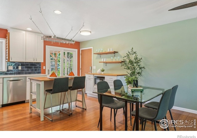 1430 Kennedy Ave, Louisville, CO 80027 - kitchen featuring dishwasher, recessed lighting, backsplash, light wood-style flooring, and white cabinets