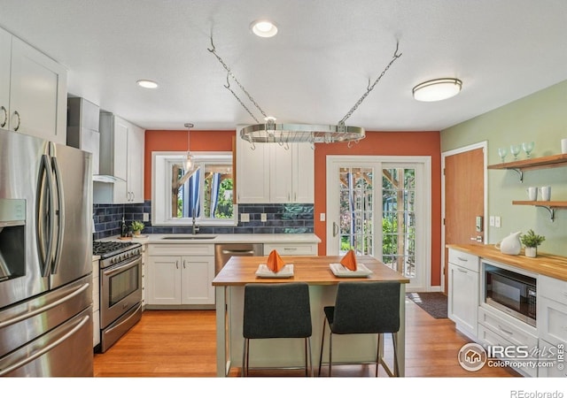 1430 Kennedy Ave, Louisville, CO 80027 - kitchen with appliances with stainless steel finishes, wooden counters, decorative backsplash, plenty of natural light, and recessed lighting