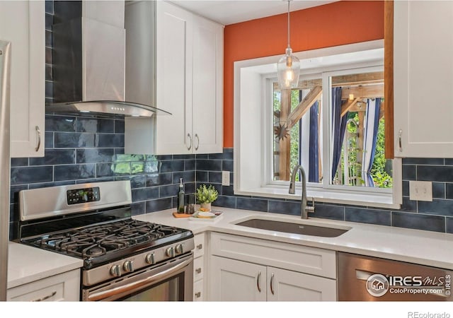 1430 Kennedy Ave, Louisville, CO 80027 - kitchen with appliances with stainless steel finishes, wall chimney range hood, white cabinets, and light countertops