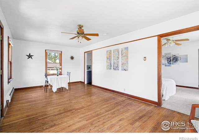 612 20th St, Greeley, CO 80631 - empty room featuring ceiling fan, wood finished floors, and baseboard heating