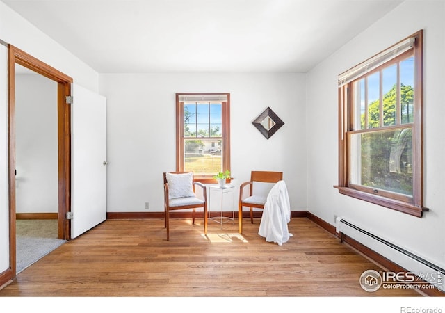 612 20th St, Greeley, CO 80631 - living area featuring a baseboard radiator and light wood finished floors