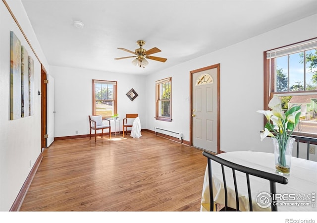 612 20th St, Greeley, CO 80631 - foyer featuring baseboard heating, plenty of natural light, light wood finished floors, and ceiling fan