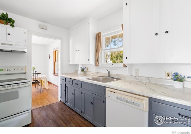 612 20th St, Greeley, CO 80631 - kitchen featuring white appliances, under cabinet range hood, gray cabinets, dark wood-style floors, and white cabinetry