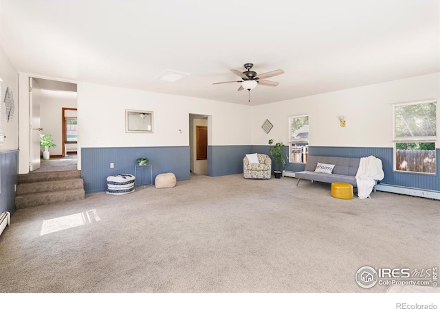 612 20th St, Greeley, CO 80631 - carpeted living room featuring a wainscoted wall and ceiling fan