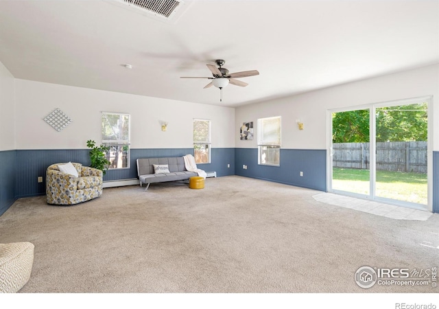 612 20th St, Greeley, CO 80631 - sitting room featuring carpet floors, wainscoting, ceiling fan, and a baseboard heating unit
