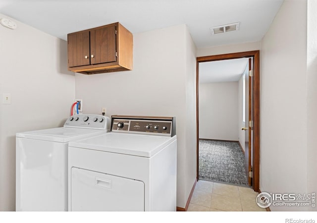 612 20th St, Greeley, CO 80631 - laundry room with cabinet space, separate washer and dryer, and light tile patterned floors