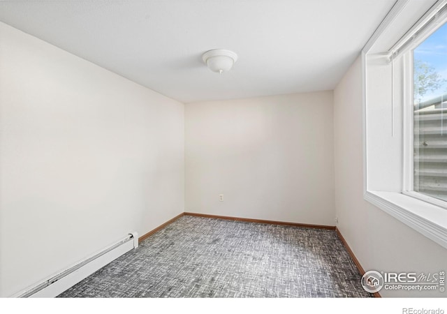 612 20th St, Greeley, CO 80631 - spare room with a baseboard heating unit and carpet