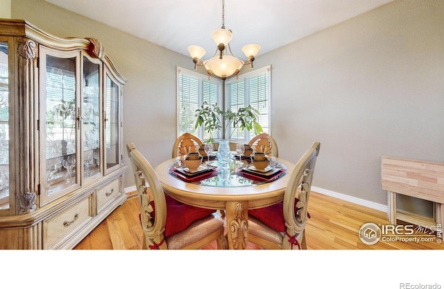 7294 Tamarisk Dr, Fort Collins, CO 80528 - dining area featuring light wood-style floors and a chandelier