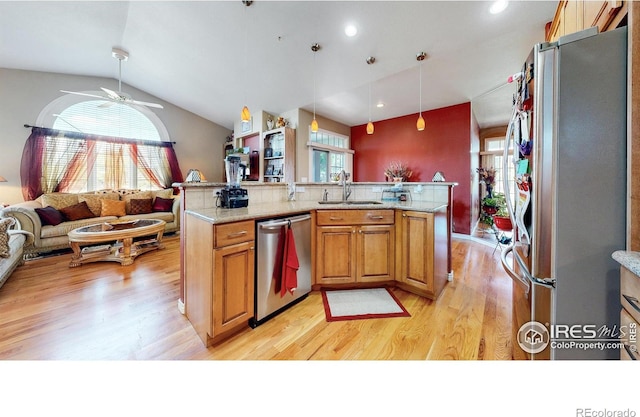 7294 Tamarisk Dr, Fort Collins, CO 80528 - kitchen featuring stainless steel appliances, vaulted ceiling, light wood-type flooring, ceiling fan, and open floor plan