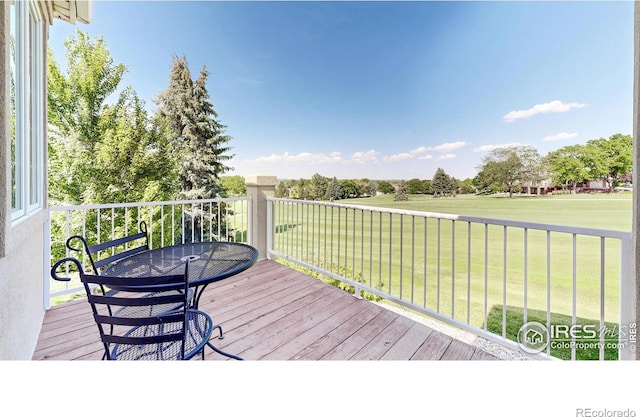 7294 Tamarisk Dr, Fort Collins, CO 80528 - wooden terrace featuring a lawn and outdoor dining area