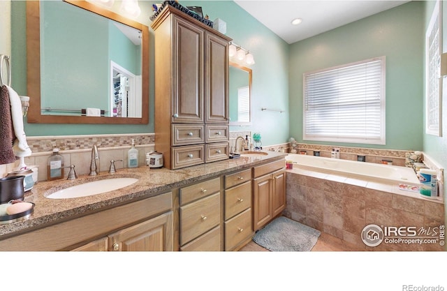 7294 Tamarisk Dr, Fort Collins, CO 80528 - full bath with double vanity, a bath, and tile patterned floors