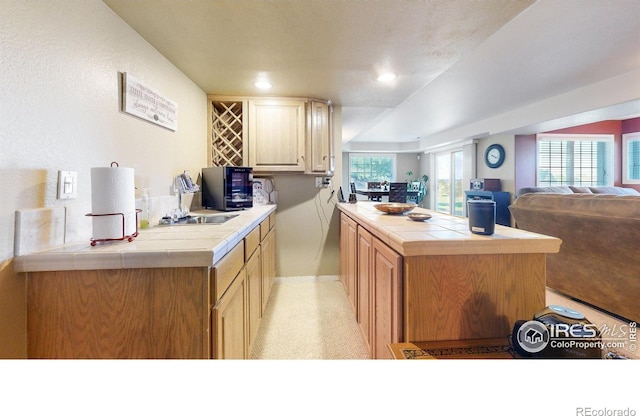 7294 Tamarisk Dr, Fort Collins, CO 80528 - kitchen with tile countertops, open floor plan, recessed lighting, and a peninsula