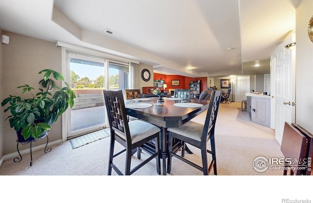 7294 Tamarisk Dr, Fort Collins, CO 80528 - dining room featuring light colored carpet and baseboards