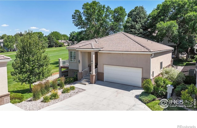 7294 Tamarisk Dr, Fort Collins, CO 80528 - single story home with concrete driveway, an attached garage, a tile roof, stucco siding, and stone siding