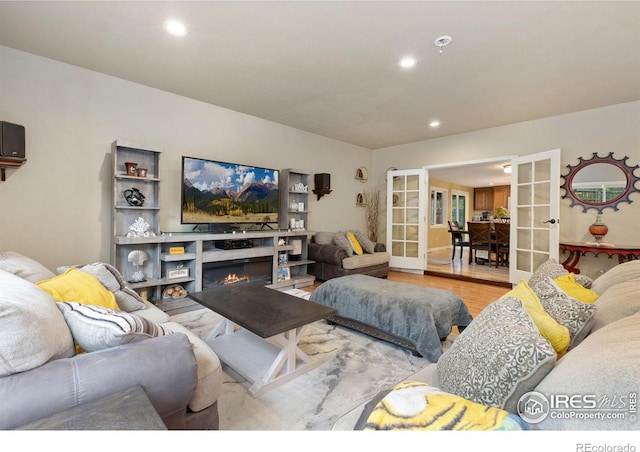 144 Placer Ave, Longmont, CO 80504 - living area with french doors, recessed lighting, wood finished floors, and a glass covered fireplace