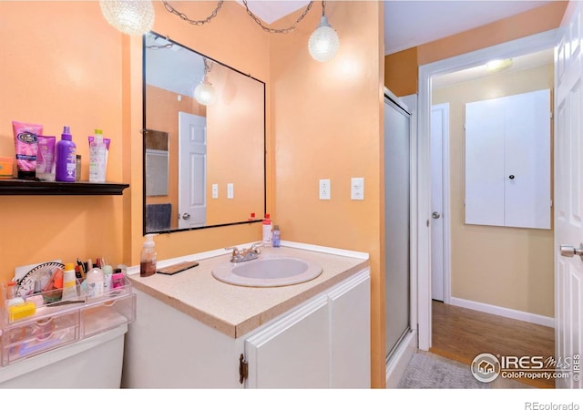144 Placer Ave, Longmont, CO 80504 - bathroom with vanity, a stall shower, and wood finished floors