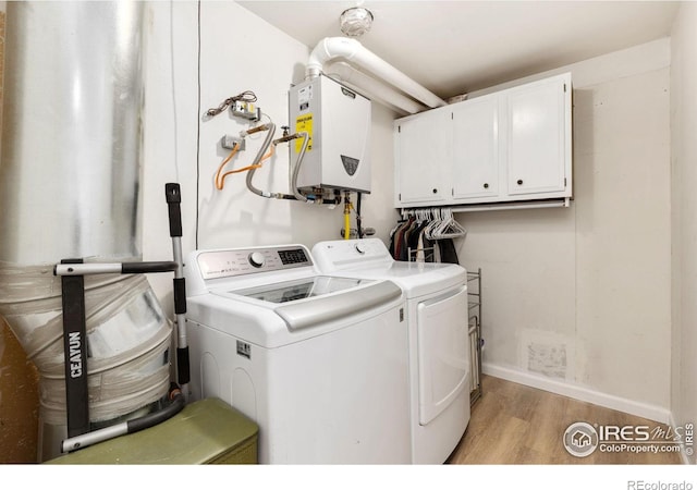 144 Placer Ave, Longmont, CO 80504 - laundry area with cabinet space, independent washer and dryer, tankless water heater, and light wood-type flooring
