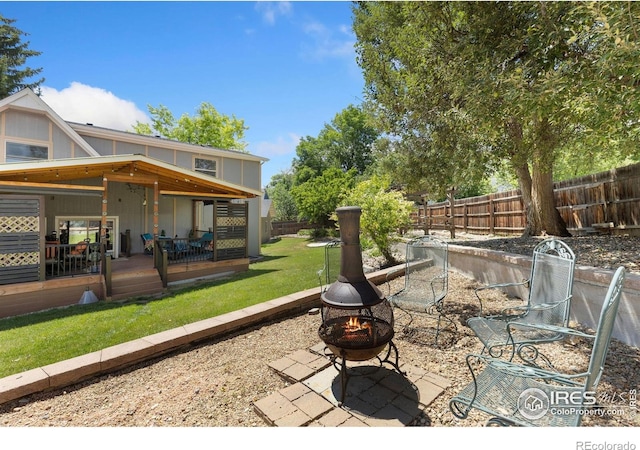144 Placer Ave, Longmont, CO 80504 - fenced backyard featuring a fire pit, a patio area, and a wooden deck