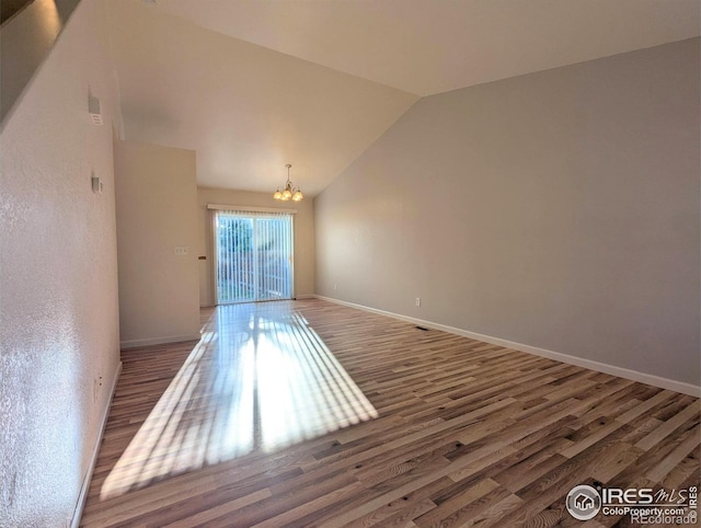 3705 Dove Ln, Evans, CO 80620 - unfurnished room featuring a chandelier, wood finished floors, and lofted ceiling