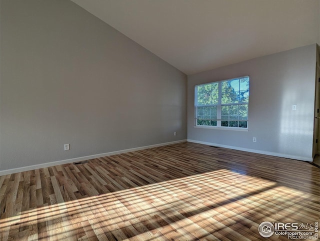 3705 Dove Ln, Evans, CO 80620 - empty room featuring wood finished floors and lofted ceiling
