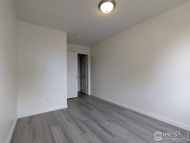 3705 Dove Ln, Evans, CO 80620 - empty room with dark wood-style flooring and baseboards