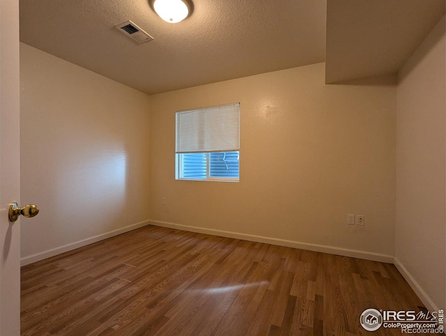 3705 Dove Ln, Evans, CO 80620 - empty room with wood finished floors and a textured ceiling