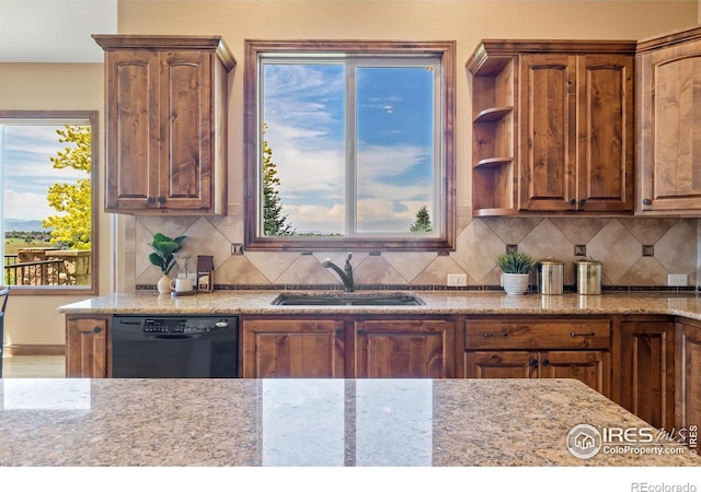 8276 Blackwood Dr, Windsor, CO 80550 - kitchen with dishwasher, light stone counters, and tasteful backsplash
