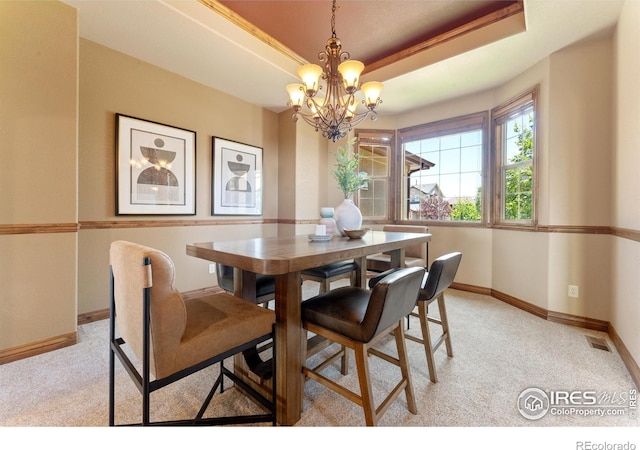8276 Blackwood Dr, Windsor, CO 80550 - dining area with a chandelier, light colored carpet, and a tray ceiling